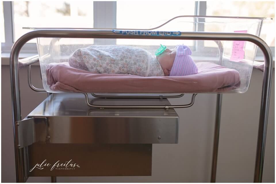 newborn baby in hospital bassinette near the window