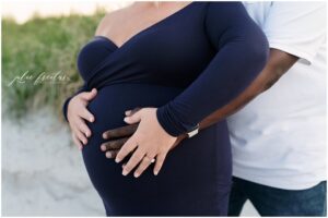 couple expecting their first baby with hands on mom's belly